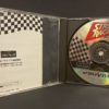 Intérieur de la boîte du jeu "Street Racer Extra". Le disque du jeu et la notice est présente.